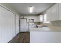 Bright kitchen featuring white cabinetry, modern appliances, and wood-look floors at 256 Turnstone Rd, Stockbridge, GA 30281