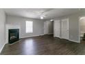 Spacious living room with a cozy fireplace, dark wood flooring, and plenty of natural light at 256 Turnstone Rd, Stockbridge, GA 30281