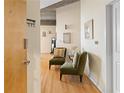 Inviting hallway with hardwood floors, cozy seating area, and stylish decor at 400 W Peachtree Nw St # 3114, Atlanta, GA 30308