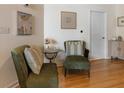 Charming hallway featuring hardwood floors, accent seating, and elegant wall decor at 400 W Peachtree Nw St # 3114, Atlanta, GA 30308