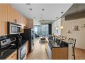 Modern kitchen featuring stainless steel appliances, sleek countertops, and breakfast bar at 400 W Peachtree Nw St # 3114, Atlanta, GA 30308