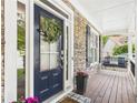 Inviting front door with stone accents and a cozy seating area on the porch at 122 White Spruce Ct, Dallas, GA 30157