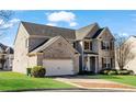 Charming two-story brick home with a well-manicured lawn and two car garage at 2468 Cannon Farm Ln, Duluth, GA 30097
