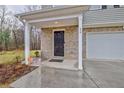 Inviting covered front porch with brick detail and a secure Vivint security system at 370 Cassidy Trl, Douglasville, GA 30134