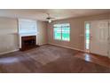 Spacious living room features fireplace and natural light from entry at 7250 Bridgeport Ct, Austell, GA 30168