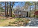 Exterior showcasing a charming two-story home with a brick base and siding, complete with an attached garage at 3937 Locklear Way, Atlanta, GA 30360