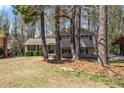 Two-story home with brick and siding exterior, surrounded by mature trees and a green lawn at 3937 Locklear Way, Atlanta, GA 30360