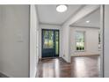 Bright foyer with dark hardwood floors and a glass paneled front door at 3937 Locklear Way, Atlanta, GA 30360