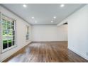 Spacious living room featuring hardwood floors, neutral walls, recessed lights and large windows at 3937 Locklear Way, Atlanta, GA 30360