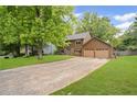 Spacious driveway leading to a well-maintained home with a two-car garage and a verdant lawn at 4967 Jett Rd, Marietta, GA 30066