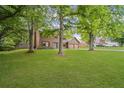 A beautiful front yard with mature trees frames a well-maintained home with a lush green lawn at 4967 Jett Rd, Marietta, GA 30066