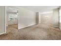 Bright living room featuring neutral paint, plush carpet, and ample space for entertaining guests at 586 Chris Cir, Lawrenceville, GA 30044