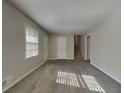 Open living area with neutral paint, new carpet, and ample natural light at 586 Chris Cir, Lawrenceville, GA 30044