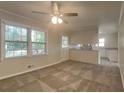 Bright living room featuring large windows, neutral paint, and modern ceiling fan at 586 Chris Cir, Lawrenceville, GA 30044