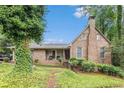 Charming brick home featuring a chimney and covered front porch, nestled in a lush, green landscape at 6230 S Summers S Cir, Douglasville, GA 30135