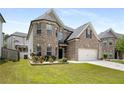Beautiful brick home with lush green lawn, an attached two-car garage, and manicured landscaping at 829 Overlook Path Ln, Lawrenceville, GA 30045