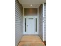 A welcoming entrance with a white front door framed by sidelights at 275 Green Commons Dr, Covington, GA 30016