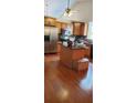 Well-lit kitchen with wood cabinets, stainless steel appliances, and center island at 999 Simonton Glen Dr, Lawrenceville, GA 30045