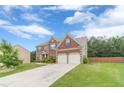 Two-story brick home with a two-car garage, and a well maintained front lawn in a nice neighborhood at , Loganville, GA 30052