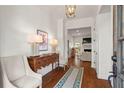 Elegant foyer featuring hardwood floors, stylish decor, and a glimpse into the living area, creating a warm welcome at 1429 Noel Ne Dr, Brookhaven, GA 30319