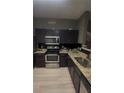 Well-equipped kitchen featuring granite countertops and modern appliances at 1794 Fielding Way, Hampton, GA 30228
