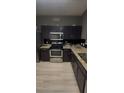 Modern kitchen with stainless steel appliances and granite countertops at 1794 Fielding Way, Hampton, GA 30228