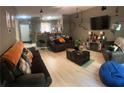 Open-concept living room with modern decor, wood-look flooring, and comfortable seating at 1794 Fielding Way, Hampton, GA 30228