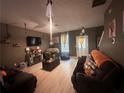 Comfortable living room with a ceiling fan, wood-look flooring, and modern decor at 1794 Fielding Way, Hampton, GA 30228