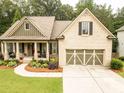 Beautifully landscaped home with a front porch and attached two-car garage at 2059 Ivey Chase Dr, Dacula, GA 30019