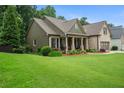 Well-maintained home with a lush green lawn and established landscaping at 2059 Ivey Chase Dr, Dacula, GA 30019