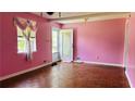 Pink living room with hardwood floors and a bright window at 472 Opel St, Riverdale, GA 30274