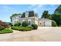 Beautiful home with an expansive driveway, showcasing well-maintained landscaping and an attached garage at 4720 Cliffside Ct, Marietta, GA 30067