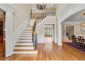 Inviting foyer boasts a grand staircase with detailed iron railings and beautiful hardwood floors at 4720 Cliffside Ct, Marietta, GA 30067