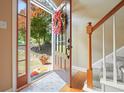 Inviting entryway with wood floors, a staircase, and a view of the landscaped yard at 921 Laurel Crest Dr, Woodstock, GA 30189
