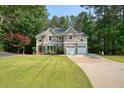 Beautiful two-story home with a well-maintained lawn and a spacious driveway at 921 Laurel Crest Dr, Woodstock, GA 30189