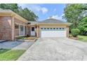 The garage of the brick home with a large driveway and well-manicured landscaping at 1758 N Springs Dr, Atlanta, GA 30338