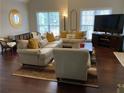 Bright living room featuring hardwood floors, large windows, and comfortable seating at 340 Fountainmist Trl, Lawrenceville, GA 30043