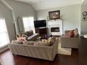 Spacious living room with fireplace, hardwood floors, and large windows offering natural light at 340 Fountainmist Trl, Lawrenceville, GA 30043