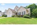 Inviting two-story home with lush landscaping and a green lawn at 5365 Twin Creeks Dr, Norcross, GA 30071