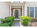 Elegant front door with stone accents and lush green landscaping at 5365 Twin Creeks Dr, Norcross, GA 30071