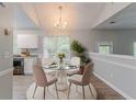 Bright dining room with a glass table, chandelier, and natural light, perfect for Gathering meals and entertaining at 5421 Salem Springs Dr, Lithonia, GA 30038