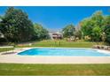 Large in-ground pool with surrounding patio and fenced backyard, perfect for outdoor enjoyment at 1851 Harvest Way, Loganville, GA 30052