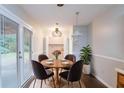 Cozy dining area with a stylish chandelier, a round wooden table and backyard access at 604 Hamlet Se Ct, Conyers, GA 30094