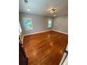 This bright bedroom offers hardwood floors and neutral paint for a modern, spacious feel at 2319 Beecher Sw Rd, Atlanta, GA 30311