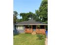 Charming single-story home features a welcoming front porch and a well-manicured lawn at 2319 Beecher Sw Rd, Atlanta, GA 30311