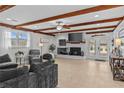 Comfortable living room with hardwood floors, brick fireplace, exposed beams, and bright natural light at 4739 Lower Jersey Rd, Oxford, GA 30054