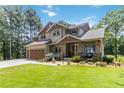 Beautiful two-story home with a landscaped front yard and a spacious two-car garage at 1268 Harris Road Rd, Lawrenceville, GA 30043