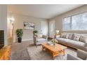 Cozy living room featuring neutral tones, plush seating, and ample natural light at 1410 Willow Dr, Riverdale, GA 30296