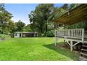 A backyard featuring a wooden deck, shed, and partial car port at 1550 Bells Ferry Rd, Marietta, GA 30066