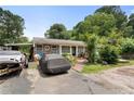 A house with a covered car port and gray car covered in black tarp at 1550 Bells Ferry Rd, Marietta, GA 30066